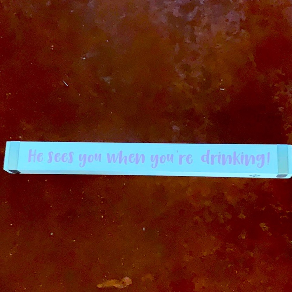 Wooden sign he see you when you’re drinking